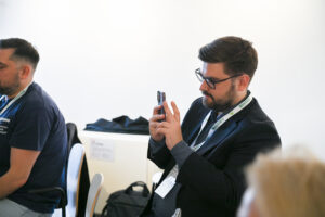 uczestnik Forum robi zdjęcie panelowi